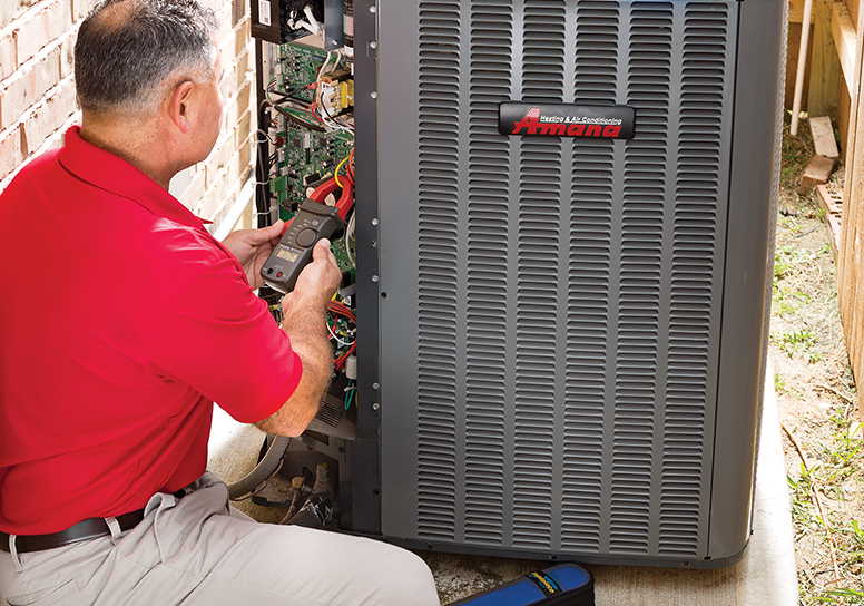 AC technician checking an outdoor ac unit