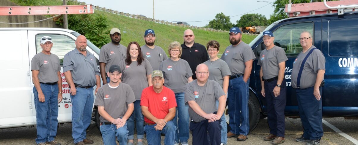 Ables Inc. team posing in front of vans