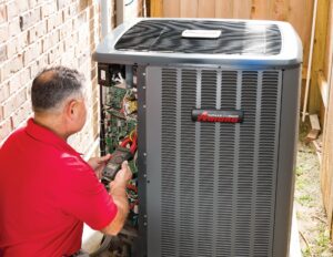 technician works on AC unit
